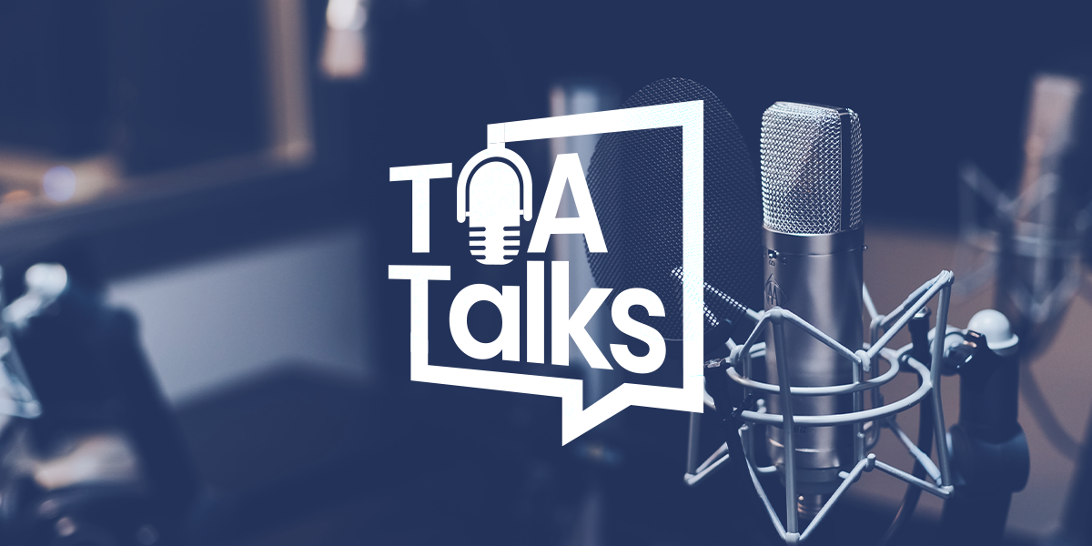 Three studio microphones with the text "TOA Talks" overlaid, featuring a speech bubble and a microphone icon.